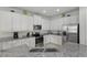 Modern kitchen featuring white cabinets, granite countertops, stainless steel appliances, and recessed lighting at 785 Desert Mountain Ct, Reunion, FL 34747