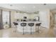 Bright kitchen with white cabinets, granite countertops, stainless steel appliances, and bar seating at 785 Desert Mountain Ct, Reunion, FL 34747