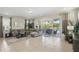 Living room features a comfortable sectional, large windows with patio access, and neutral decor at 785 Desert Mountain Ct, Reunion, FL 34747