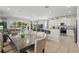 Open concept living area with tile floors, dining table, kitchen, and patio access at 785 Desert Mountain Ct, Reunion, FL 34747