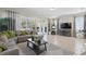 Comfortable living room featuring a sectional, large windows with patio access, and a TV at 785 Desert Mountain Ct, Reunion, FL 34747