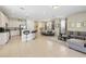 Open concept living area with tile floors, dining table, bar seating, and a modern kitchen at 785 Desert Mountain Ct, Reunion, FL 34747
