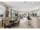Open concept living area with tile floors, dining table, bar seating, and patio access at 785 Desert Mountain Ct, Reunion, FL 34747