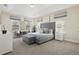 Spacious main bedroom with tray ceiling, sitting area, and large windows, creating a relaxing retreat at 785 Desert Mountain Ct, Reunion, FL 34747