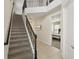 Carpeted staircase with wrought iron railing leading to the second floor, with bedroom view on the upper landing at 785 Desert Mountain Ct, Reunion, FL 34747