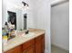 Bathroom featuring a vanity with a light countertop, wood cabinets, and a mirror over the sink at 7924 Coot St, Orlando, FL 32822