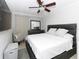 Bedroom featuring a large bed, ceiling fan, and dresser with mirror, creating a comfortable space at 7924 Coot St, Orlando, FL 32822