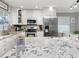 Modern kitchen with granite countertops, stainless steel appliances and white cabinetry at 7924 Coot St, Orlando, FL 32822
