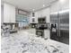 Bright kitchen featuring stainless steel appliances, granite countertops, and tile flooring at 7924 Coot St, Orlando, FL 32822