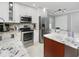 Bright kitchen with granite countertops, stainless steel appliances, and white cabinetry at 7924 Coot St, Orlando, FL 32822