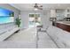 Cozy living room with view of the kitchen and sliding glass doors leading to the backyard pool at 7924 Coot St, Orlando, FL 32822