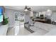 Bright living room area featuring access to the kitchen and views of the backyard pool at 7924 Coot St, Orlando, FL 32822