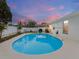 Backyard swimming pool with a white fence, featuring a partially covered outdoor kitchen area and landscaping at 7924 Coot St, Orlando, FL 32822