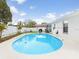 Fenced backyard pool featuring an outdoor kitchen and a well-maintained lawn for outdoor enjoyment at 7924 Coot St, Orlando, FL 32822