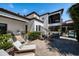 Backyard features travertine patio, seating areas, lush landscaping, and refreshing pool at 808 Golfpark Dr, Celebration, FL 34747