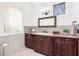 Bathroom featuring a vanity with dark wood cabinets, tile floors, and neutral paint at 808 Golfpark Dr, Celebration, FL 34747