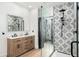 Stylish bathroom featuring double vanity, walk-in shower with patterned tile and glass enclosure, providing a spa-like experience at 808 Golfpark Dr, Celebration, FL 34747