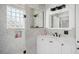 Well-lit bathroom featuring a glass block window and white vanity at 808 Golfpark Dr, Celebration, FL 34747