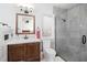 Modern bathroom features a glass shower, a wood vanity, and stylish fixtures at 808 Golfpark Dr, Celebration, FL 34747