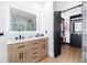 Modern bathroom boasting double sinks, lighted mirror, and sliding barn door, offering a luxurious and contemporary feel at 808 Golfpark Dr, Celebration, FL 34747