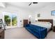 Bedroom with garden access features a plush sofa and a sleek, modern dresser at 808 Golfpark Dr, Celebration, FL 34747