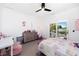 Bright bedroom with a ceiling fan and a sliding glass door to a balcony at 808 Golfpark Dr, Celebration, FL 34747
