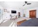 Bright bedroom featuring a ceiling fan, desk, and large window, creating a comfortable and functional space at 808 Golfpark Dr, Celebration, FL 34747