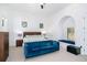 Bright bedroom featuring a blue velvet couch, a window seat, and white walls at 808 Golfpark Dr, Celebration, FL 34747