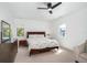 Serene bedroom featuring natural light, neutral tones, and a ceiling fan at 808 Golfpark Dr, Celebration, FL 34747
