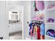 Bright walk-in closet with shelves and rack and bathroom through doorway at 808 Golfpark Dr, Celebration, FL 34747