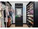 Well-organized walk-in closet with ample storage shelves, hanging rods, and a central dresser unit, maximizing space at 808 Golfpark Dr, Celebration, FL 34747