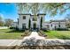 Stunning two-story home with a beautiful front yard, pathway, and architectural details at 808 Golfpark Dr, Celebration, FL 34747