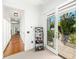 Hallway view featuring white walls, carpet floors, and access to an outdoor patio at 808 Golfpark Dr, Celebration, FL 34747