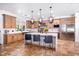Spacious kitchen with a large island, stainless steel appliances, and designer lighting at 808 Golfpark Dr, Celebration, FL 34747