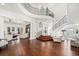 Open-concept living space with hardwood floors, staircase, and an abundance of natural light at 808 Golfpark Dr, Celebration, FL 34747