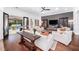 Spacious living room with hardwood floors, comfortable seating, and french doors overlooking the pool at 808 Golfpark Dr, Celebration, FL 34747