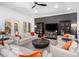 Comfortable living room with built-in shelving, a dark accent wall, and neutral furniture at 808 Golfpark Dr, Celebration, FL 34747