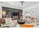 Spacious living room with hardwood floors, stylish furnishings, and a dark accent wall at 808 Golfpark Dr, Celebration, FL 34747