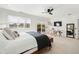 Bright main bedroom with a sitting area, tv, and access to a private balcony with bright natural light at 808 Golfpark Dr, Celebration, FL 34747