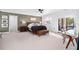Bright main bedroom with a sitting area, tv, and access to a private balcony with bright natural light at 808 Golfpark Dr, Celebration, FL 34747