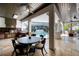 A screened outdoor kitchen with a tile floor and ceiling fan, offers an upscale dining experience at 808 Golfpark Dr, Celebration, FL 34747