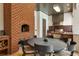 An outdoor kitchen features a brick pizza oven and stainless steel BBQ, perfect for entertaining guests at 808 Golfpark Dr, Celebration, FL 34747