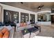 Covered outdoor living space with comfortable seating, a fire pit, and views of the backyard and pool at 808 Golfpark Dr, Celebration, FL 34747