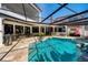 Beautiful backyard pool with screened enclosure, outdoor kitchen, and ample space for entertaining at 808 Golfpark Dr, Celebration, FL 34747