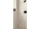 Close-up of a newly remodeled shower stall with gray and white tile and modern fixtures at 808 Golfpark Dr, Celebration, FL 34747