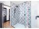 Updated bathroom featuring a walk-in shower with patterned tile, glass enclosure, and sleek black fixtures, for a luxurious experience at 808 Golfpark Dr, Celebration, FL 34747
