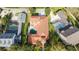 Aerial view showcases a home with private pool and landscaping in a residential neighborhood at 8437 Lake Burden Cir, Windermere, FL 34786