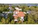 Stunning aerial view of a luxurious home surrounded by lush greenery and a serene lake at 8437 Lake Burden Cir, Windermere, FL 34786