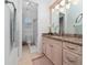 Bright bathroom featuring a vanity with granite countertop, a separate toilet and shower at 8437 Lake Burden Cir, Windermere, FL 34786