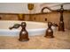 Closeup of bronze faucet against backdrop of a bathtub with bronze fixtures at 8437 Lake Burden Cir, Windermere, FL 34786